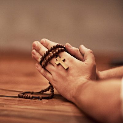 Hes always there to answer your prayers. Cropped shot of a man holding a rosary and praying